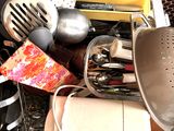 many kitchen utensils and other kitchen items in a dishwasher