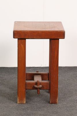 an image of a small wooden stool with a wooden seat