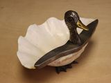 a small bird that is sitting in a bowl