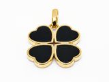 a gold four leaf clover pendant on a white background