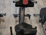 a row of stationary exercise bikes in a gym
