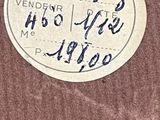 a sticker on the back of a brown suitcase
