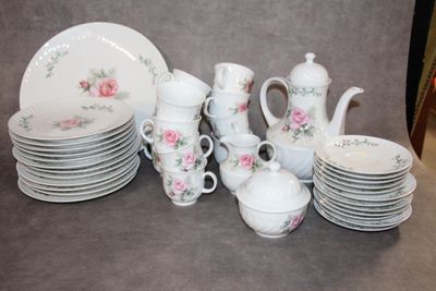 a lot of plates and cups that are on the table