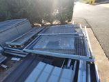 a pile of metal sheets sitting on the side of the road