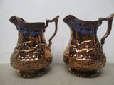 une paire de cruches anciennes en cuivre recouvertes d'un émail bleu