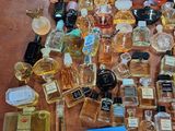 a lot of perfume bottles on a table with a price tag