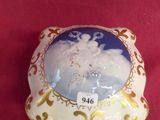 a small porcelain box with a picture of a snowman on it