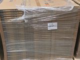 une grande pile de cartons sur une palette dans un entrepôt