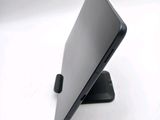 a black laptop sitting on a stand on a white surface