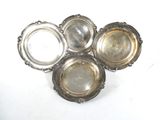 four silver plated dishes on a white surface with a white background