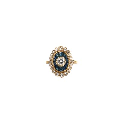 an image of a gold ring with a blue and white diamond center