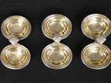 three silver and gold plated bowls with diamond accents on a black surface