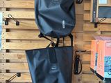 two bags hanging on the wall in the store