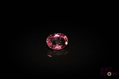 a pink diamond on a black surface