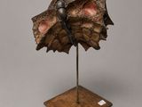 a close up of a sculpture of a shell on a stand