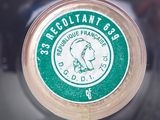 a close up of a green and white label on a bottle