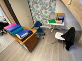 a room with a desk, chair, and bookshelf in it