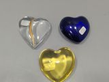 three heart shaped glass pieces on the table