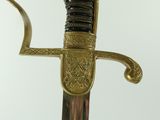 a gold and black sword with a black handle