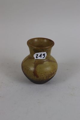 a small brown vase with a number on it
