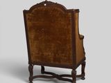an old fashioned chair with a brown velvet upholstered back