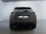 the back of a grey car in a large room with a ceiling