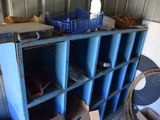 a blue shelf with blue bins on it in a room