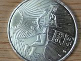 an image of a silver coin on a wooden surface