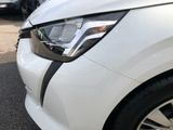 a close up of a white car with a black stripe on it