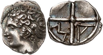 a silver coin with an image of a man and a cross on it
