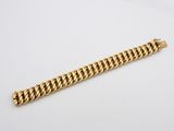 a gold chain bracelet on a white background