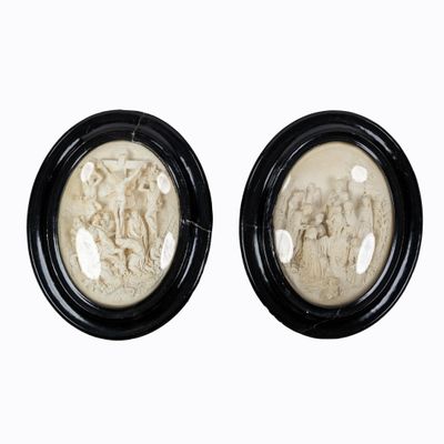 pair of black and white picture frames with figures on them