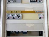 a white electrical panel with a bunch of electrical wires