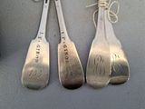 three spoons that have been stamped with names on them