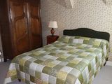 a bed with a quilt on it in a room