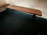 a wooden bench in the corner of a room