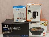 several boxes of food are stacked on a table with a blender