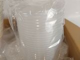 many plastic cups sitting in a box on the counter