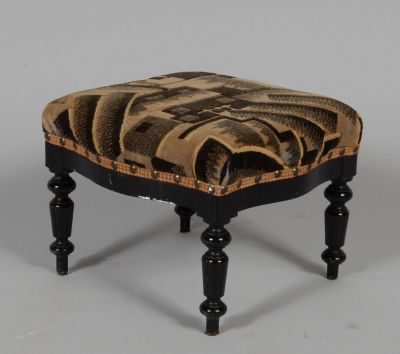 a small black stool with a brown and black design on it