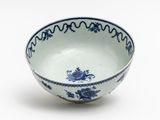 a blue and white bowl sitting on a white surface