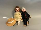 two dolls sitting next to each other on a table