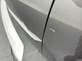 a close up of a car ' s door handle with a sticker on it
