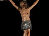statue of jesus on the cross on a black background