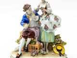 a figurine of a man and a woman sitting on a bench