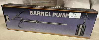 boxed box of barrel pump sitting on the floor next to a bottle of water