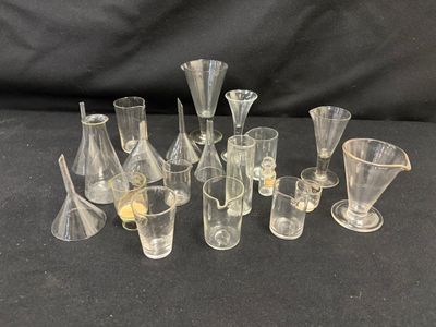 a lot of glass vases and glasses sitting on a table