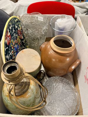 a box full of vases and other items sitting on a table