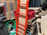 a stack of boxes and a ladder in a warehouse