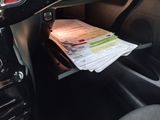 a stack of papers sitting in the back seat of a car