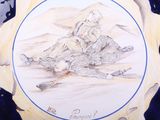 a plate with a drawing of a man sitting on the ground